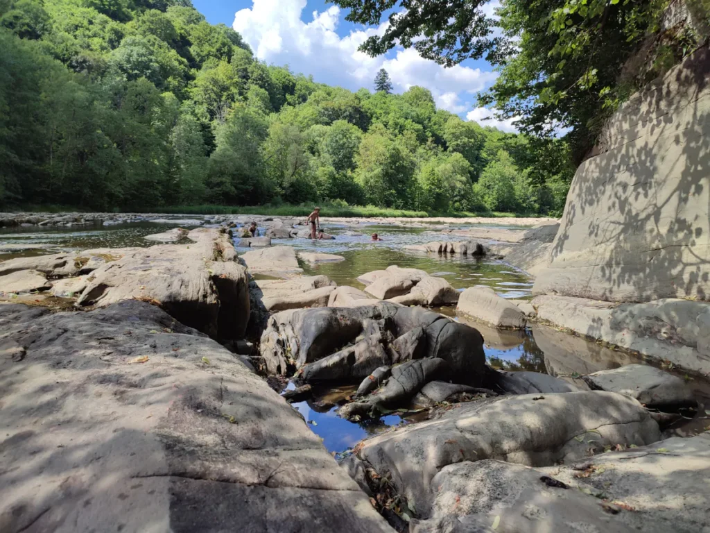San latem, skalne progi w korycie rzeki, okolice domków W Dolinie Sanu w Zatwarnicy